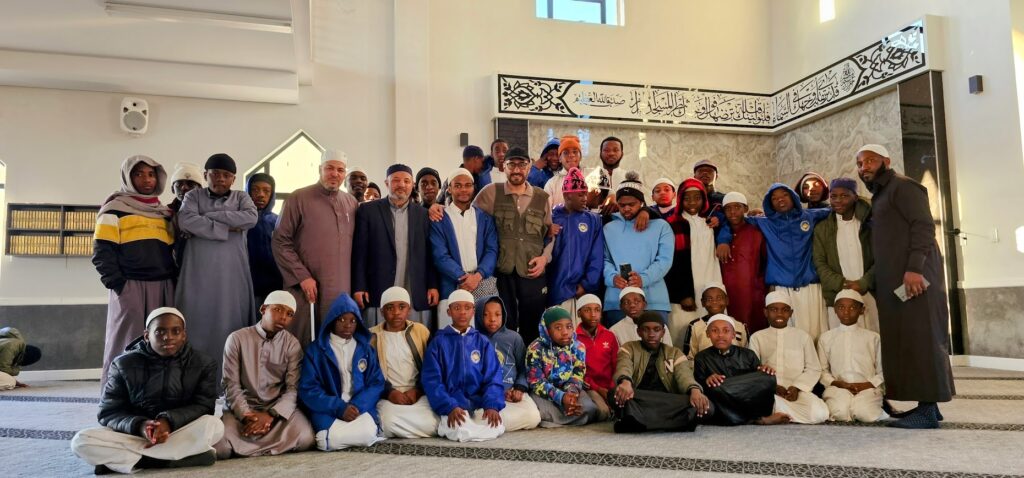 a group of students from annur gathered in the masjid with the team