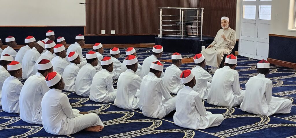 annur students gathering around one of annur teachers to learn Quran and islamic teachings