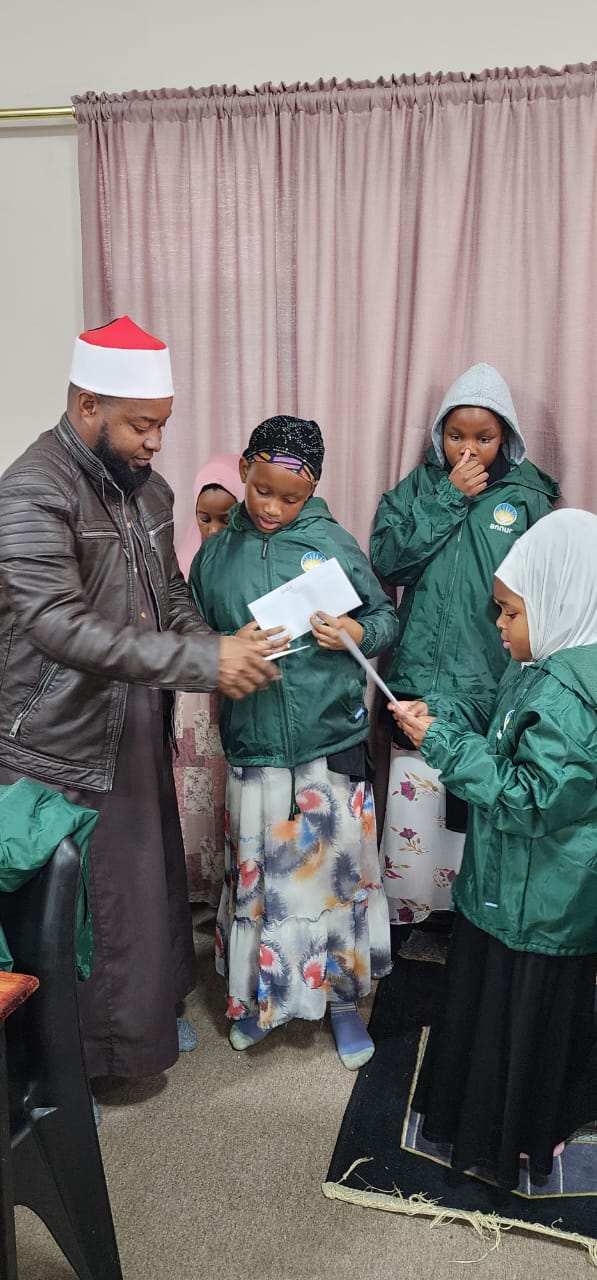 a group of students from annur gathered in the masjid with the team